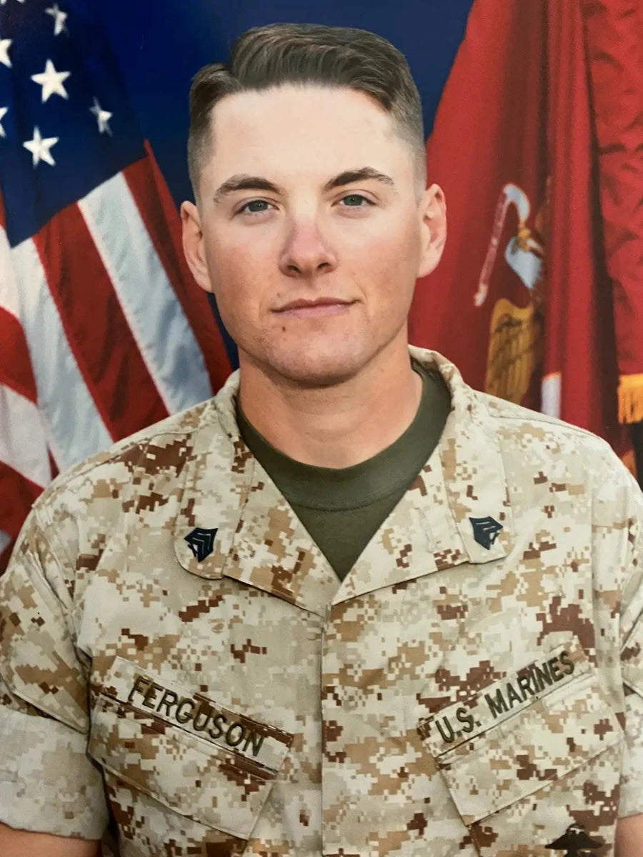 US Marine Corps Sergeant Steven Ferguson in front of American and USMC flag at School of Infantry West as a combat instructor