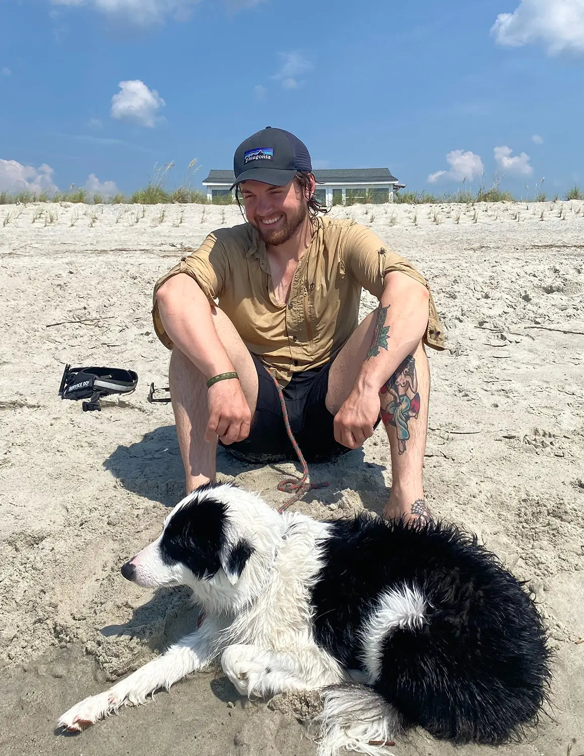 Steven a Marine Veteran with his service dog Venus a border collie on the beach