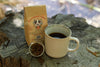 Honorhead Coffee package with a mug and coffee beans on a wooden surface